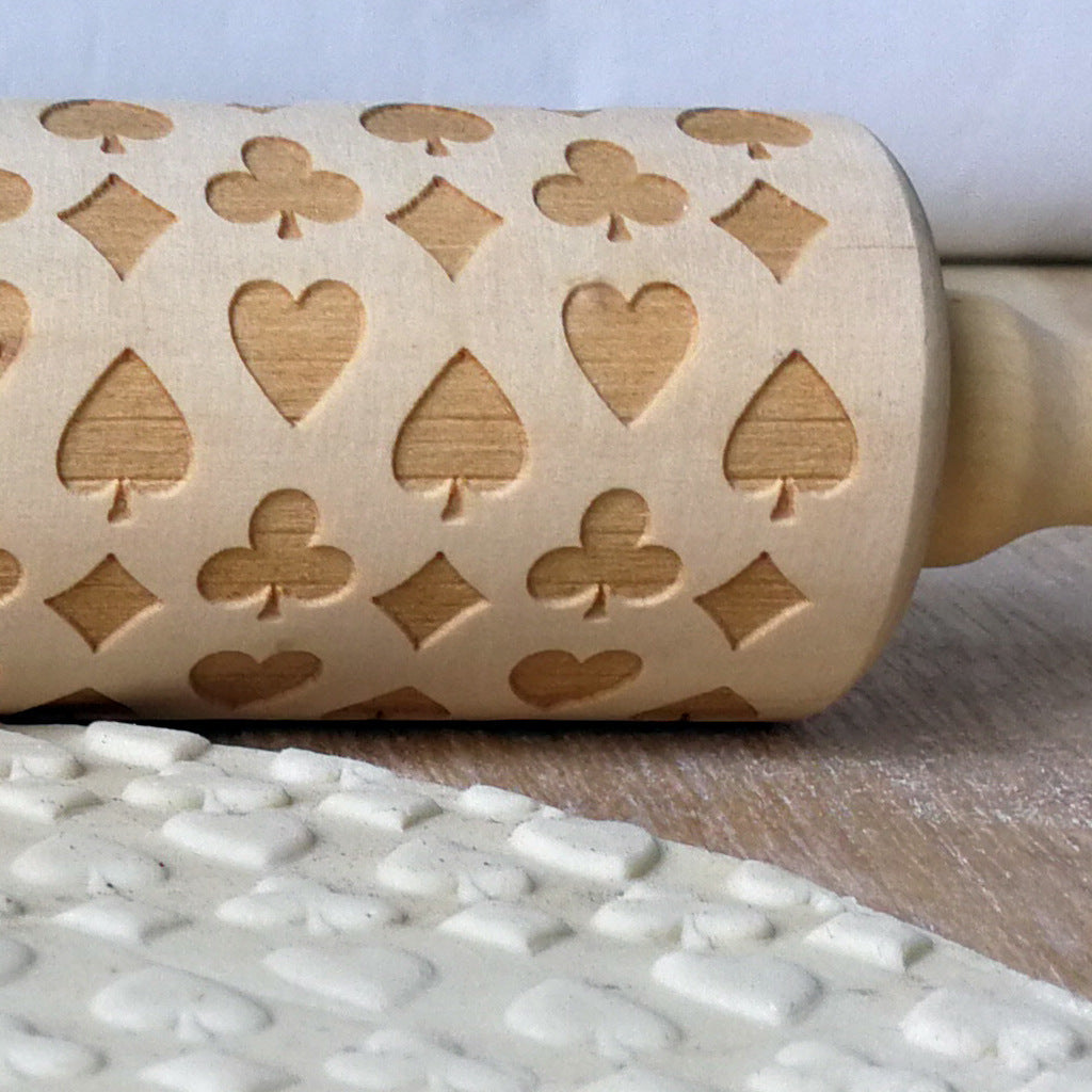 Wooden Christmas poker printing rolling pin with festive holiday patterns, ideal for baking and adding holiday cheer to treats.