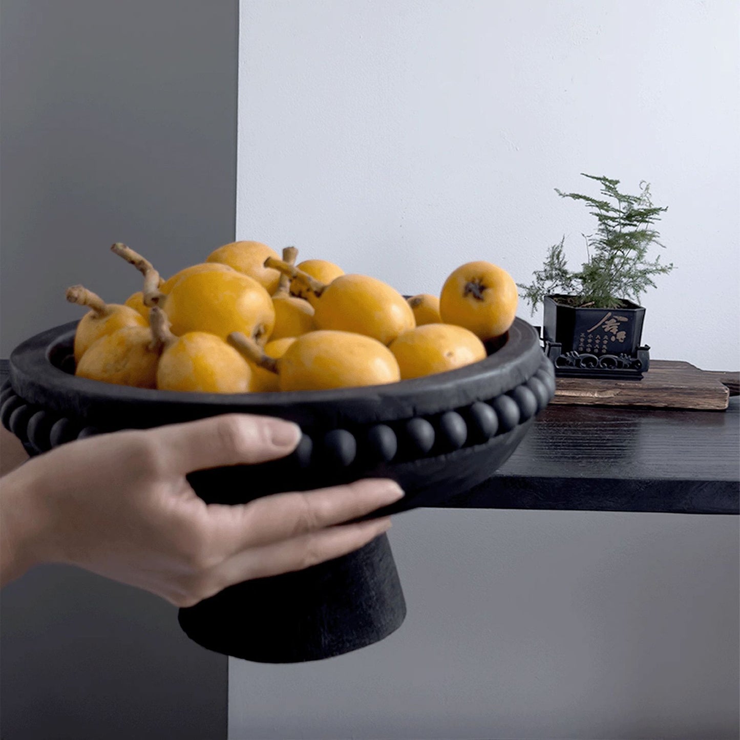 Black solid wood fruit plate in Wabi-Sabi style by WoodyKitchenware, featuring a minimalist, natural wood finish.