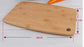 Square bamboo cutting board by WoodyKitchenware, natural wood surface with smooth edges, ideal for food prep and serving.