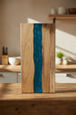 Square resin-acacia serving board by WoodyKitchenware with epoxy timber fusion, showcasing natural wood and vibrant resin details.