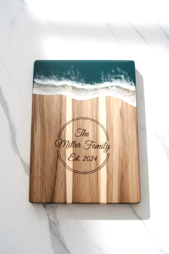 Personalized acacia mangium wooden board by WoodyKitchenware, perfect for wedding or housewarming gift, with engraved design.